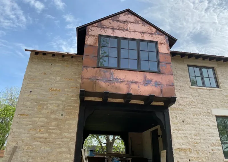 Copper metal panel facade on a stone building for Skylight Installation in Castle Rock